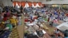 People take shelter from typhoon Hagupit in an evacuation center in Surigao city, southern Philippines, Dec. 5, 2014.