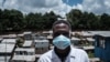 A staff member of local NGO Shining Hope for Communities wears a face mask as a preventive measure against the COVID-19 coronavirus as the NGO installs hand-washing stations at the Kibera slum in Nairobi, March 18, 2020. 