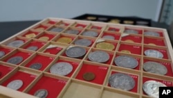 Coins from L. E. Bruun's collection on display on a wooden tray, in Zealand, Denmark, May 7, 2024. The large collection could get up to $72 million. (AP Photo/James Brooks)