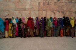Wearing protective masks, women stand in line to enter the Grand Mosque of Touba as they take part in the celebrations of the Grand Magal of Touba, Senegal, Oct. 5, 2020.