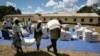 Zimbabwean villagers collect their monthly rations of food aid about 254km north of Harare March 7, 2013. 