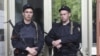 Russian police officers guard the entrance of the building where Russian opposition leader Alexei Navalny resides during a police search in Moscow, June 11, 2012. 