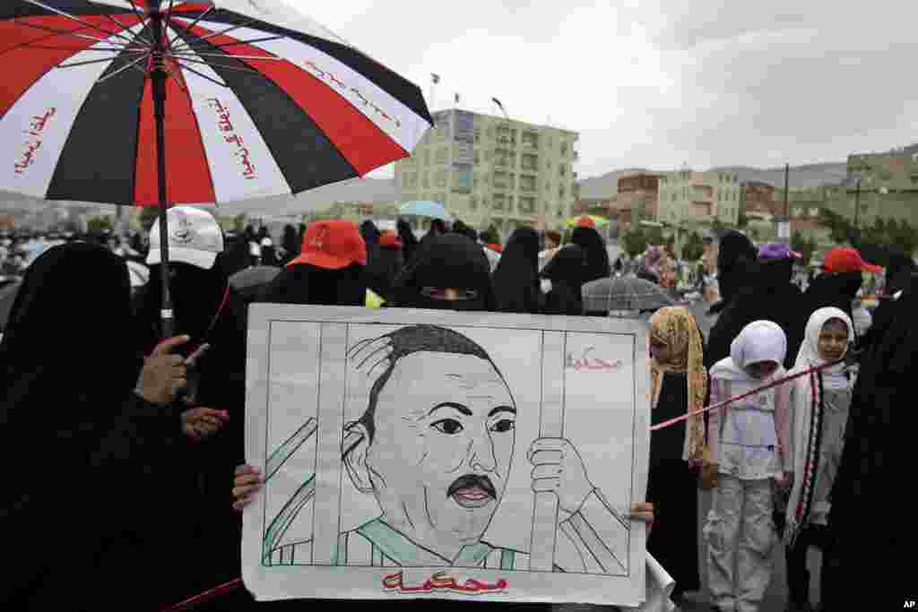 August 12, 2011: A female anti-government demonstrator holds a placard demanding the prosecution of Yemen's President Ali Abdullah Saleh in Sanaa.