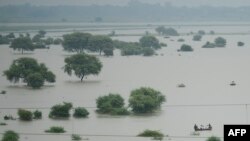 FILE - An aerial view shows villagers using boats to cross a flooded Ganges river, in Allahabad, Uttar Pradesh, India, Aug. 21, 2019. 