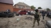 Investigators work at the site of a suicide bomb attack in the Malgobek district in the north of Ingushetia, August 19, 2012.