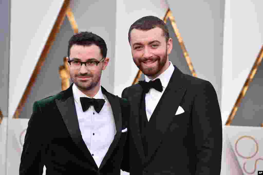 Sam Smith, right, and Jimmy Napes arrive at the Oscars on Feb. 28, 2016, at the Dolby Theatre in Los Angeles.