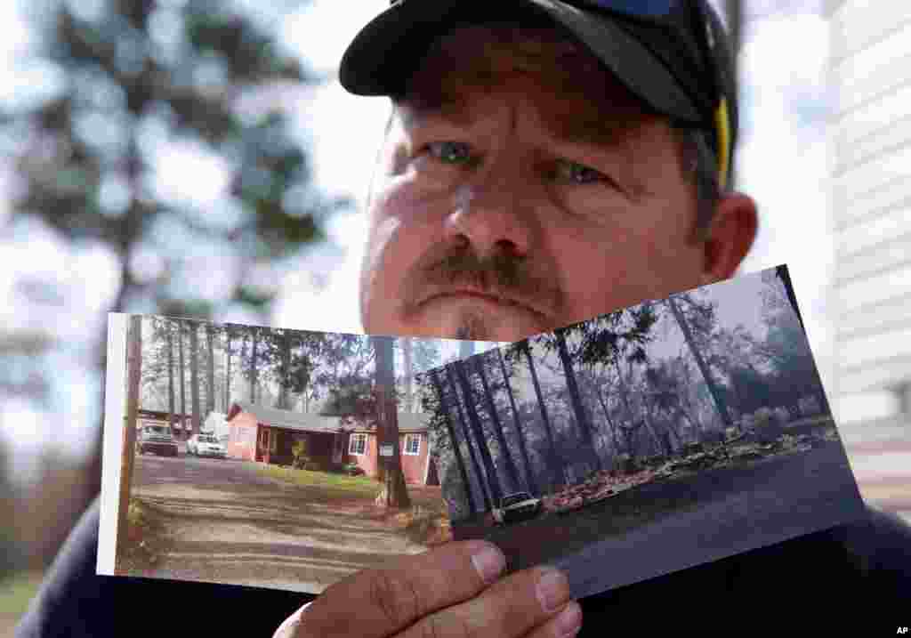 Bill Husa displays before-and-after photos of his home, Oct. 24, 2019, lost in last year's Camp Fire in Paradise, Calif. Husa's home is one of nearly 9,000 Paradise homes destroyed in the deadliest and most destructive wildfire in California history.