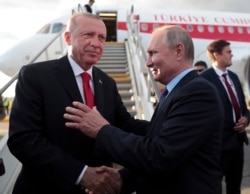 FILE - Russia's President Vladimir Putin, right, shakes hands with Turkey's President Recep Tayyip Erdogan before his departure from Zhukovsky, outside Moscow, Aug. 27, 2019.