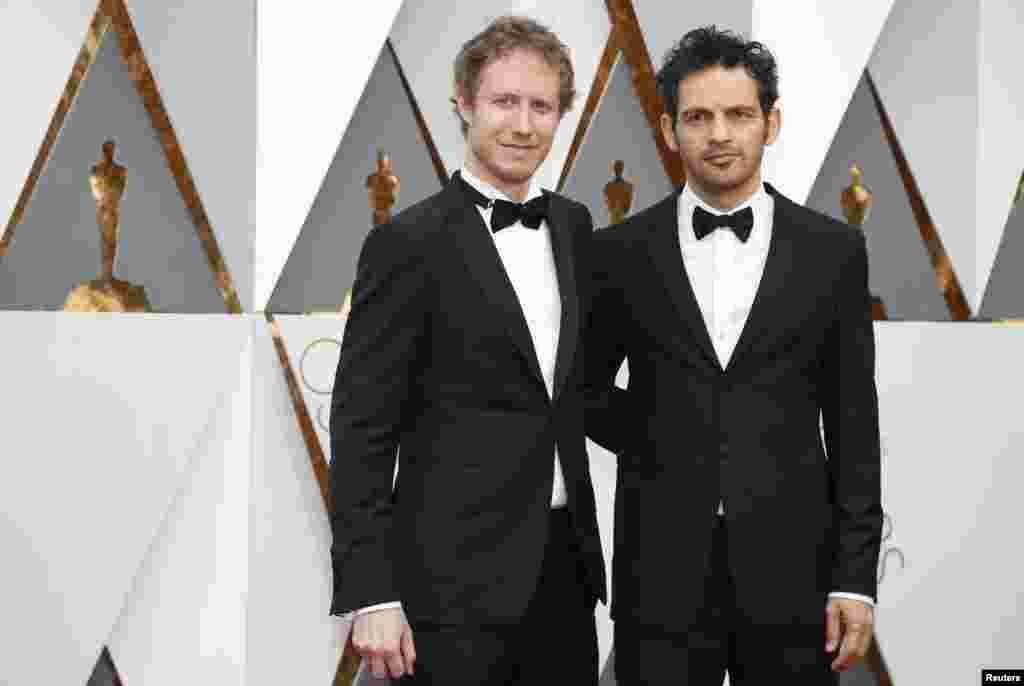 Laszlo Nemes, director of Hungary's Best Foreign Language Film nominee "Son of Saul," arrives with guest at the 88th Academy Awards in Hollywood, California, Feb. 28, 2016.