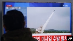 FILE - A man watches a TV news program showing file footage of missile launch conducted by North Korea, at Seoul Railway Station in Seoul, South Korea, March 3, 2016. 