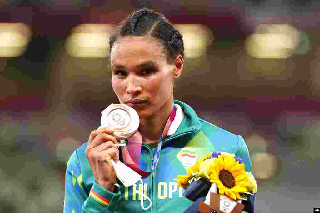 Bronze medalist Letesenbet Gidey, of Ethiopia, reacts during the medal ceremony for the women's 10,000-meters final at the 2020 Summer Olympics, Saturday, Aug. 7, 2021, in Tokyo. (AP Photo/Martin Meissner)
