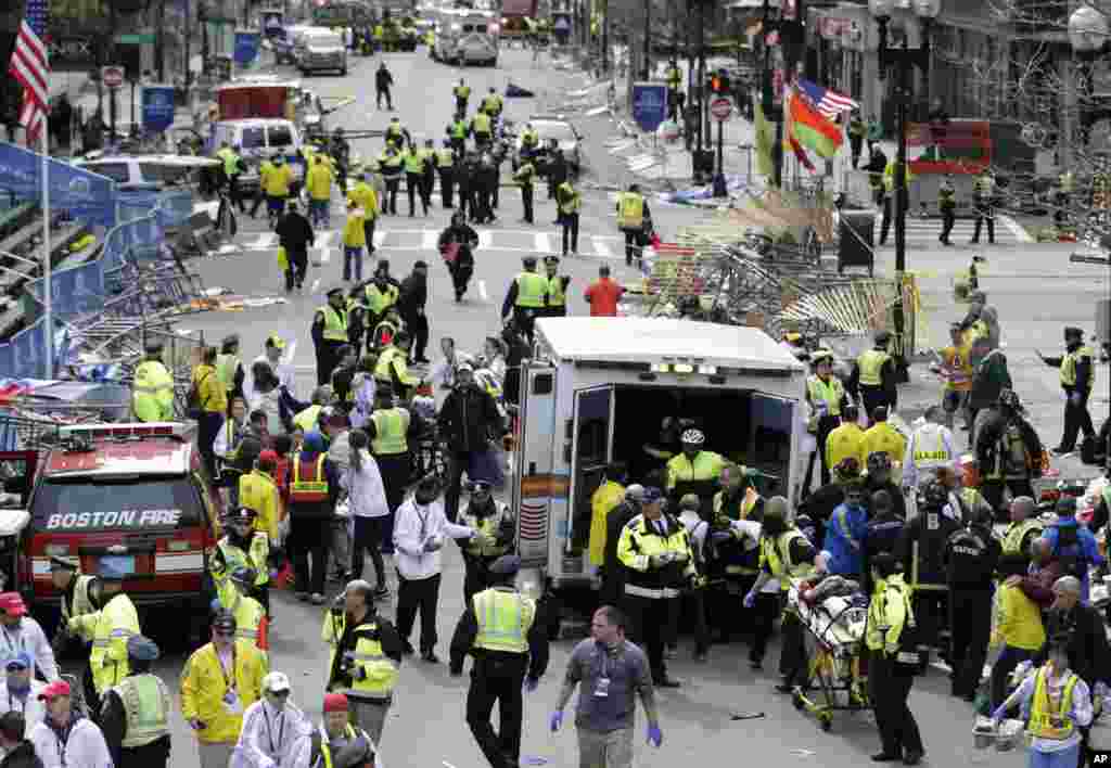 Medical workers aid injured people at the finish line of the 2013 Boston Marathon following an explosion in Boston, April 15, 2013.
