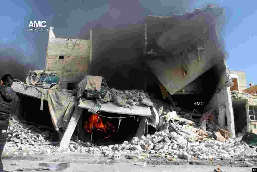 This citizen journalism image shows a destroyed building after a Syrian air strike in Aleppo, Dec. 22, 2013.