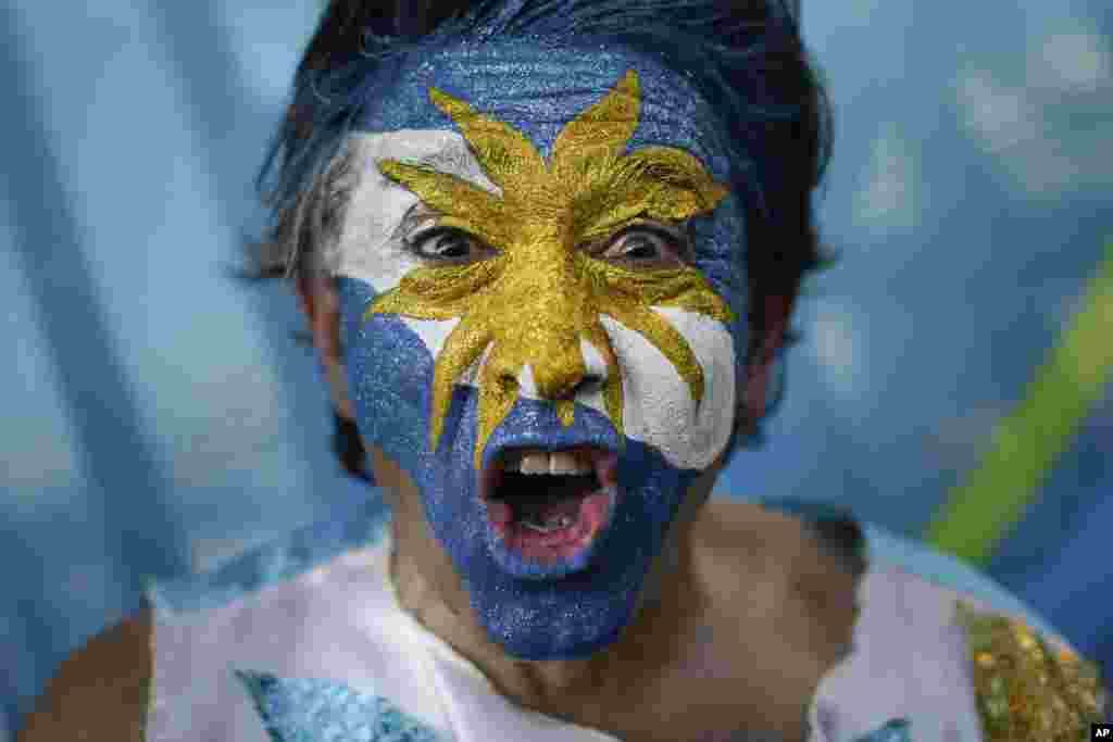 An Argentina soccer fan cheers outside the Maracana Stadium before the group F World Cup soccer match between Argentina and Bosnia, in Rio de Janeiro, Brazil, June 15, 2014.