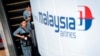 A Malaysia Airlines flight crew heads for the departure lounge at Kuala Lumpur International Airport. Malaysian civil aviation authorities officially declared the airline's Flight MH370 crash an accident on Jan. 29, 2015.