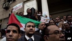 Lawyers hold a Palestinian flag during a protest after a recent U.S. decision to recognize Jerusalem as the capital of Israel, at the Lawyers Syndicate in Cairo, Egypt, Sunday, Dec. 10, 2017.
