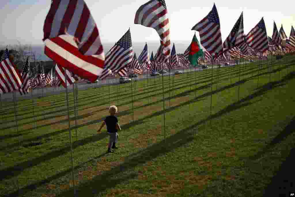 A boy runs among flags flying at Pepperdine University in honor of the victims of the September 11, 2001 attacks, Malibu, California, September 10, 2012.