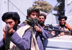Taliban forces stand guard in front of Hamid Karzai International Airport in Kabul, Afghanistan, September 2, 2021.