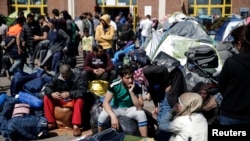 Réfugiés et migrants avec leurs bagages avant leur embarcation à destination de leur pays d'accueil au port de Piraeus, en Grèce près d'Athènes le 31 mars, 2016.
