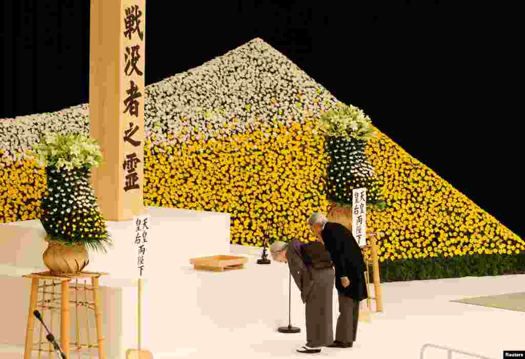 Japan's Emperor Akihito (R) and Empress Michiko honor the war dead during a memorial ceremony marking the 72nd anniversary of Japan's surrender in World War II, at Budokan Hall in Tokyo.