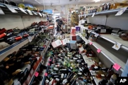 Bottles of wine are strewn in the middle of an aisle in the Eastridge Market in Ridgecrest, California, July 6,2019, after Friday night's 7.1-magnitude earthquake, which jolted an area from Sacramento to Mexico.