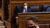 Santiago Abascal, leader of Spain's far-right party Vox, walks to give his speech as Prime Minister Pedro Sanchez looks on during a no-confidence motion against the government at parliament in Madrid, Spain, Oct. 22, 2020. (Reuters)