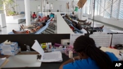 People get treatment at Haiti's first permanent cholera center, run by Gheskio Centers, in downtown Port-au-Prince, Haiti, Feb. 24, 2016.