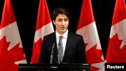 Canadian Prime Minister Justin Trudeau speaks about a deadly Saskatchewan school shooting during a news conference in Davos, Switzerland, Jan. 22, 2016.