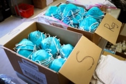 FILE PHOTO: Boxes of N95 protective masks for use by medical field personnel are seen at a New York State emergency operations incident command center during the coronavirus outbreak in New Rochelle, New York, U.S., March 17, 2020. REUTERS/Mike…