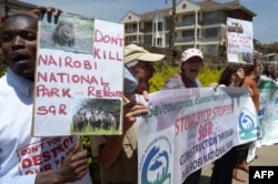 FILE - Demonstrators protest the route of Standard Gauge Railway (SGR) being built by Chinese government, which is to cut through the middle of the Nairobi National Park, at a rally outside the People’s Republic of China Embassy in Nairobi, Oct. 17, 2016.