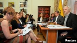 FILE - WikiLeaks founder Julian Assange, right, listens as Ecuador's Foreign Affairs Minister Ricardo Patino, second right, speaks, during a news conference at the Ecuadorian embassy in central London, Aug. 18, 2014. 