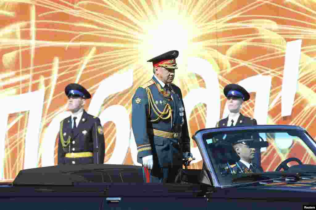 Russian Defense Minister Sergei Shoigu (C) reviews the troops during the Victory Day parade in Moscow's Red Square.