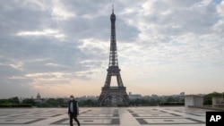 A man wears a mask to protect against the spread of the coronavirus as he walks along the Trocadero square close to the Eiffel Tower in Paris, France, April 25, 2020.