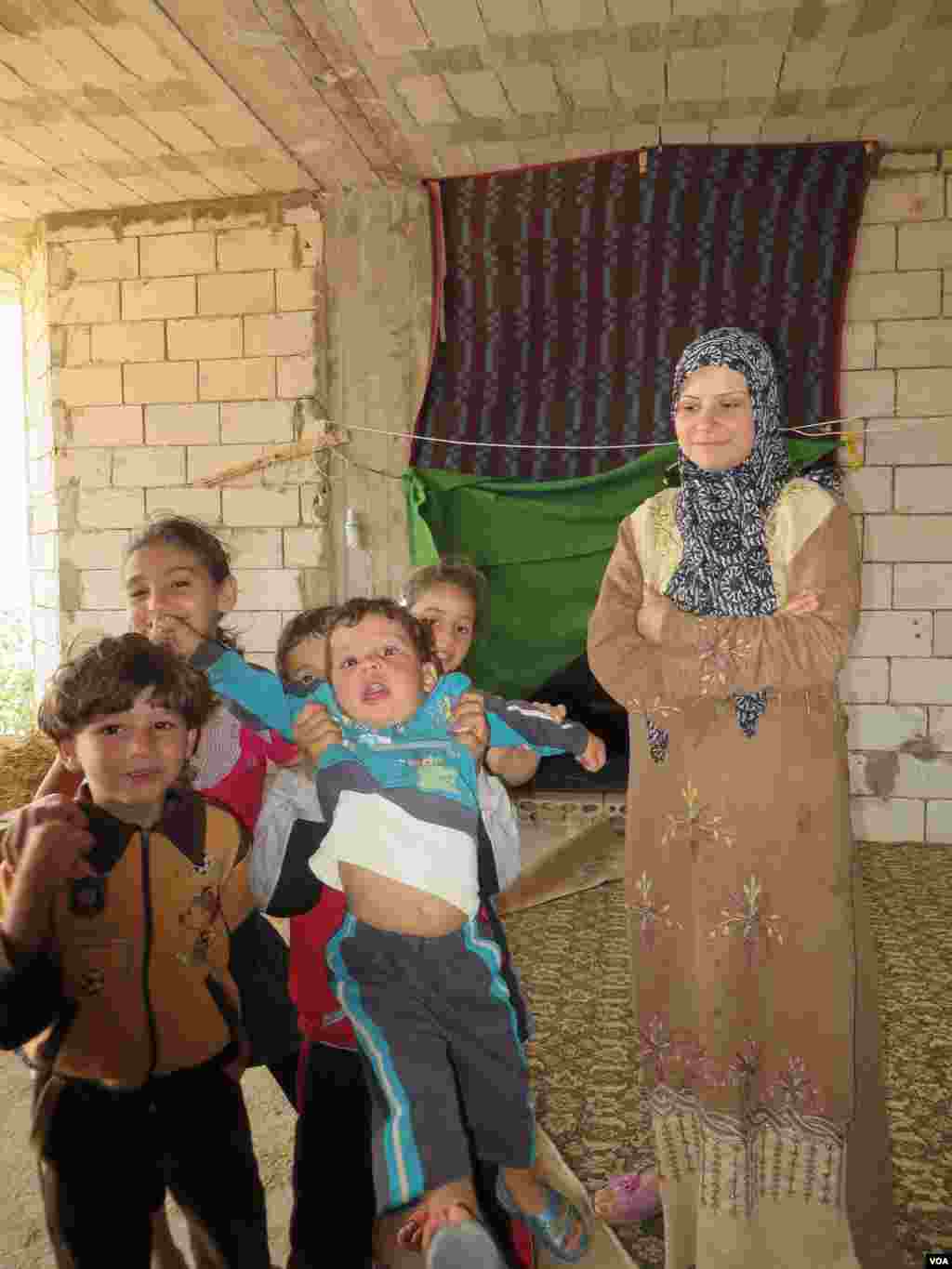 This family fled their home in Damascus last month and say they would rather live here in Lebanon, with no windows or doors to protect them from the wind than risk their lives in Syria, Bekaa Valley, Lebanon, Sept. 4, 2013. Photo: H. Murdock/VOA 