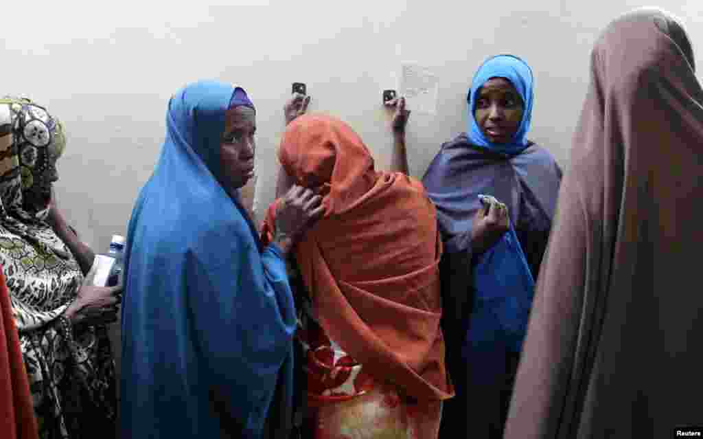 Leyla Ali Adow (C), a suspected Somali illegal migrant arrested in a police swoop, reacts after being processed for deportation at a holding station in Kenya's capital Nairobi.