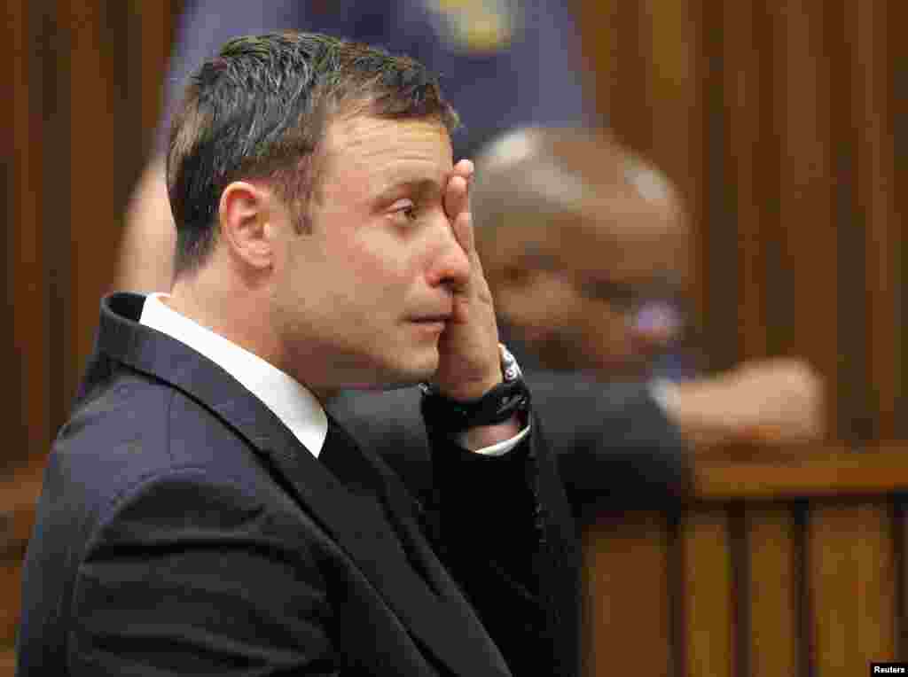 Oscar Pistorius reacts as he listens to Judge Thokozile Masipa's verdict at the North Gauteng High Court in Pretoria, Sept. 11, 2014. 