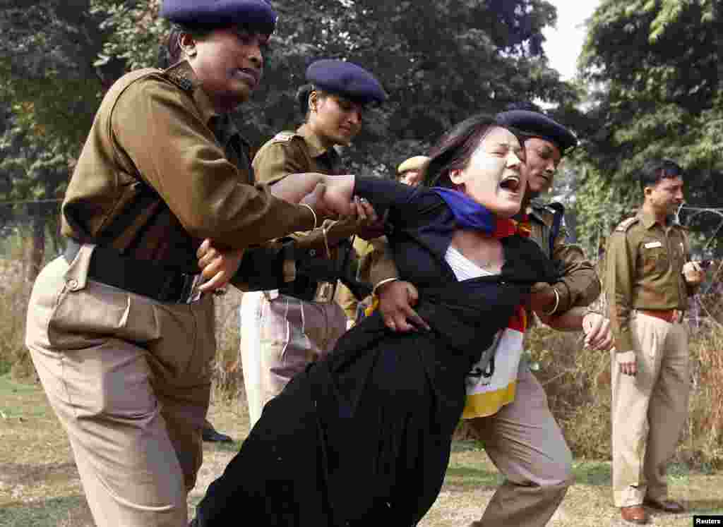 A Tibetan exile is detained by police during a protest over China's rule over Tibet, outside the Chinese embassy in New Delhi, India.