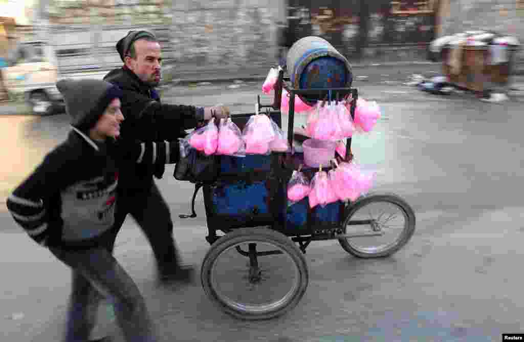 A street vendor sells cotton candy in Aleppo, January 15, 2013.