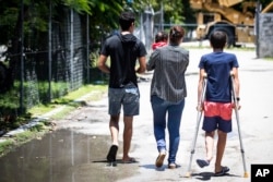 FILE - Refugees are pictured on Nauru, Sept. 4, 2018.