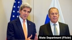 FILE - U.S. Secretary of State John Kerry, flanked by Russian Foreign Minister Sergey Lavrov, answers a reporter's question on Sept. 9, 2016, at the Hotel President Wilson in Geneva, Switzerland, before they begin a bilateral meeting focused on Syria. 