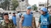The Chief of the U.N. Supervision Mission to Syria, Norwegian Major General Robert Mood (2nd R) and his team walk with members of the Free Syrian Army, at the Khalidiya neighborhood during the United Nations observers' visit to Homs, May 3, 2012.