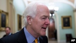 FILE - Senate Majority Whip Sen. John Cornyn, R-Texas, talks with reporters on Capitol Hill, Oct. 11, 2018 in Washington. 
