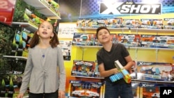 A brother and sister check out the latest gadgets at the 115th North American International Toy Fair, in New York, Feb. 17, 2018.