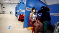 A medical worker injects the AstraZeneca coronavirus vaccine at Fiumicino Airport in Rome, Italy, March 8, 2021.