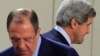 U.S. Secretary of State John Kerry (R) walks behind Russian Foreign Minister Sergei Lavrov (L) at the start of a NATO-Russia foreign ministers meeting in Brussels April 23, 2013.