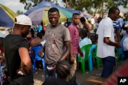 Supporters of Congolese President elect Felix Tshisekedi sell souvenirs outside his party headquarters in Kinshasa, Jan. 23, 2019. Tshisekedi is to be inaugurated Jan. 24, 2019.