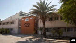 FILE - A logo adorns a wall on a branch of the Israeli NSO Group company, near the southern Israeli town of Sapir.