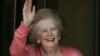 Former British Prime Minister Margaret Thatcher, gestures to members of the media as she stands on her house doorstep, following her return home from hospital, in central London, June 29, 2009.