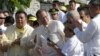 Philippine President Benigno Aquino III, center, is applauded by lawmakers after signing into law the Human Rights Victims Reparation and Recognition Act of 2013, Feb. 25, 2013.