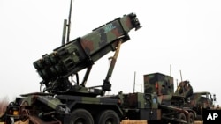 A camouflaged convoy of Dutch military trucks carrying two batteries of Patriot missiles is lined up for a media opportunity before departing De Peel Air Base in Vreedepeel, southern Netherlands, Jan. 7, 2013.